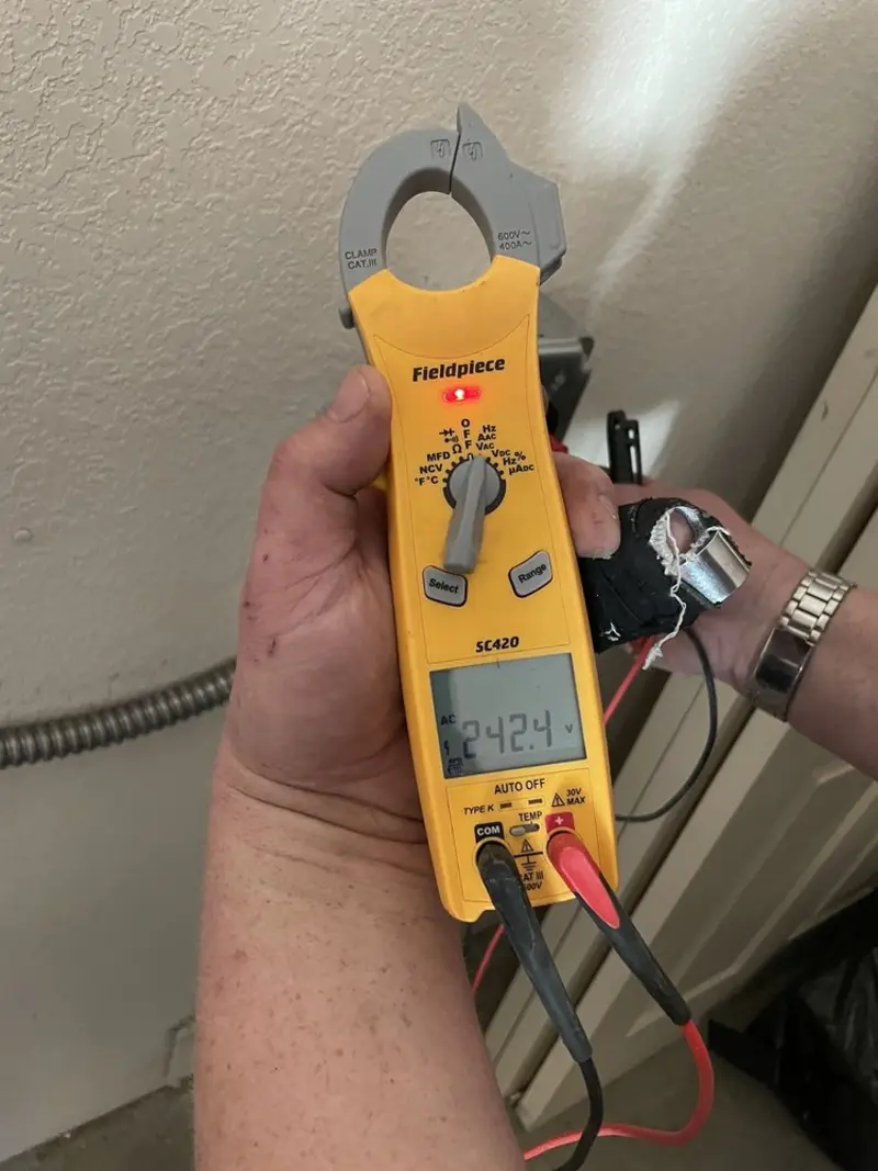 Voltage testing with clamp meter during Whole House Surge Protector in Milton